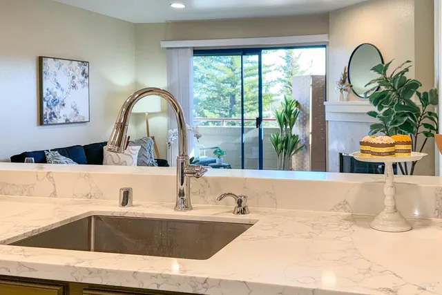 a view of a kitchen island with a large window and cabinets