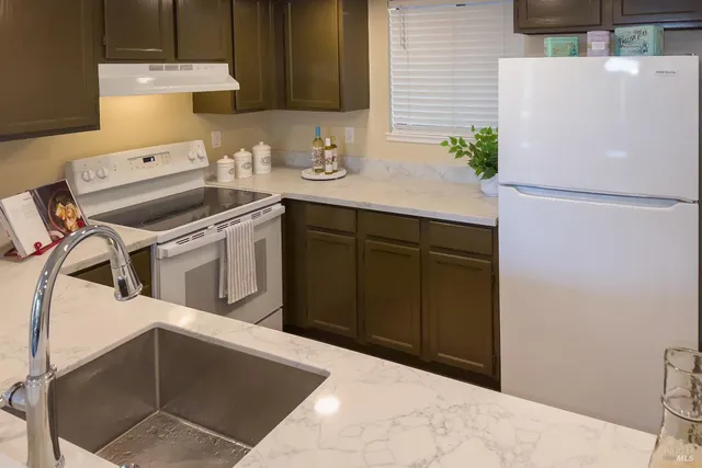 a kitchen with a sink appliances and cabinets