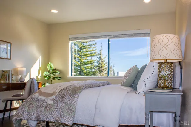 a bedroom with a bed and window