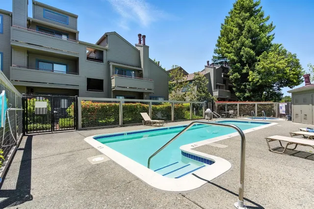 a view of a house with swimming pool and sitting area