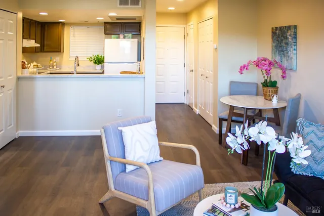 a living room with furniture and flowers