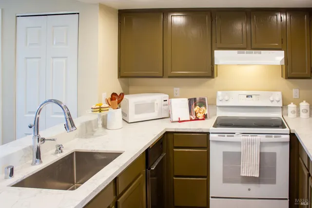 a kitchen with a sink cabinets and appliances