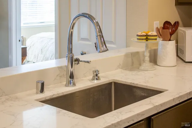 a kitchen with a sink and a mirror