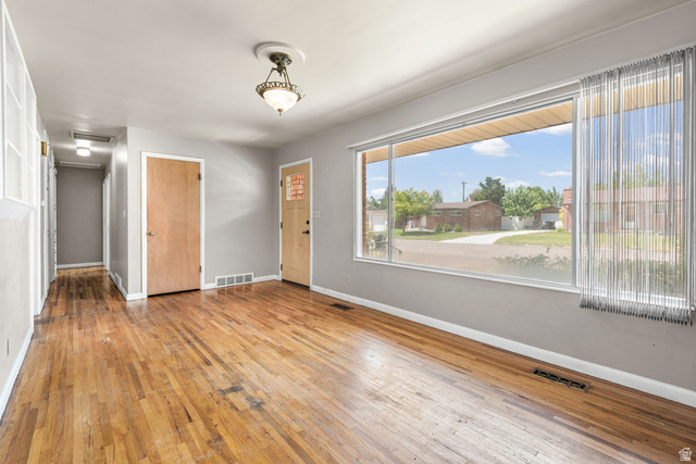 542 East 3400th Street North Provo, UT 84604 - Photo 10 of 39 Hardwood flooring throughout, featuring a large picture window, light gray wall tones, and recessed ceiling lighting