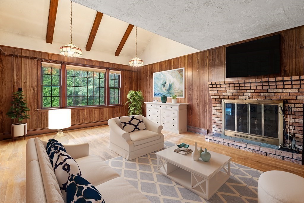 4 Woodpark Circle Lexington, MA 02421 - Photo 11 of 27 a living room with furniture a flat screen tv and a fireplace