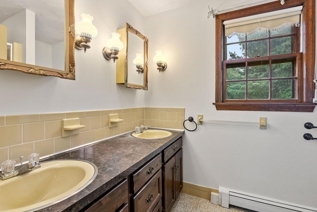 4 Woodpark Circle Lexington, MA 02421 - Photo 17 of 27 a bathroom with a granite countertop sink and a mirror