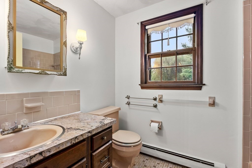 4 Woodpark Circle Lexington, MA 02421 - Photo 20 of 27 a bathroom with a granite countertop toilet sink and mirror