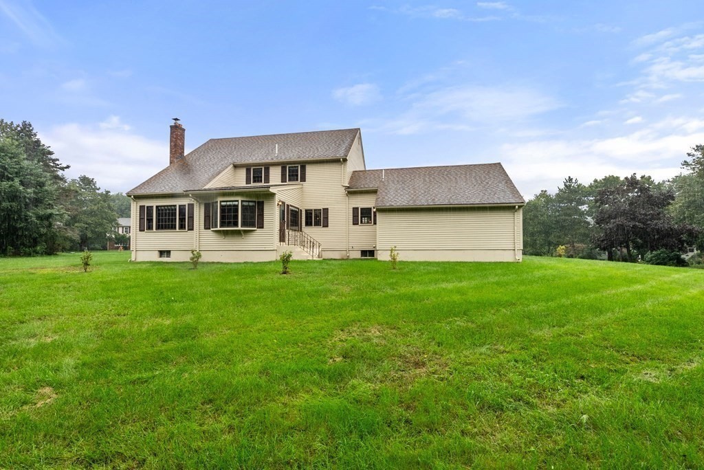 4 Woodpark Circle Lexington, MA 02421 - Photo 25 of 27 a front view of a house with a yard and trees
