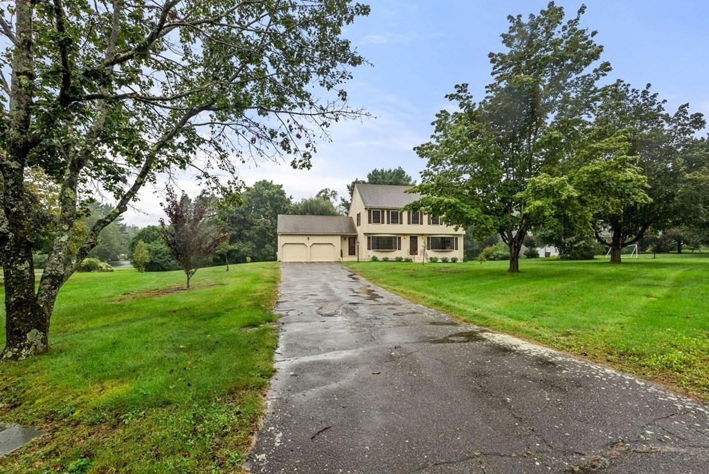 4 Woodpark Circle Lexington, MA 02421 - Photo 3 of 27 a front view of a house with a yard