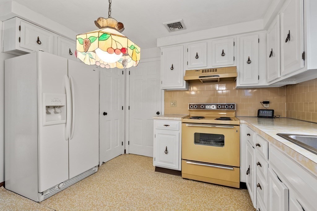 4 Woodpark Circle Lexington, MA 02421 - Photo 10 of 27 a kitchen with granite countertop white cabinets and white appliances
