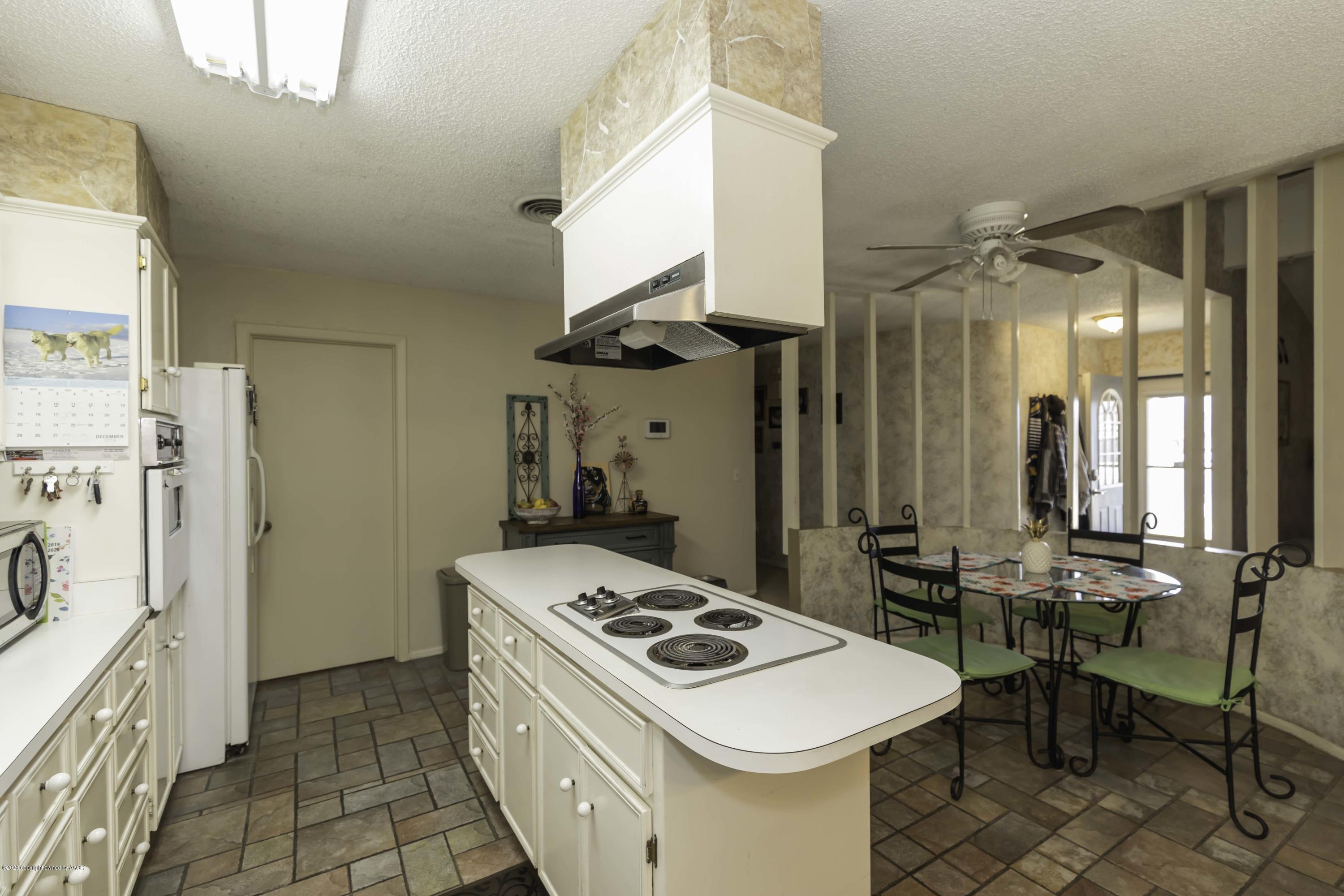4616 South Georgia Street Amarillo, TX 79110 - Photo 14 of 36 a kitchen that has a stove and a table
