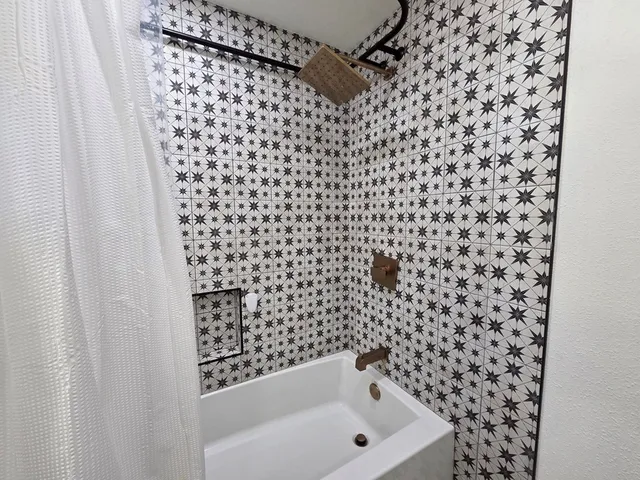 a bathroom with a bathtub and shower