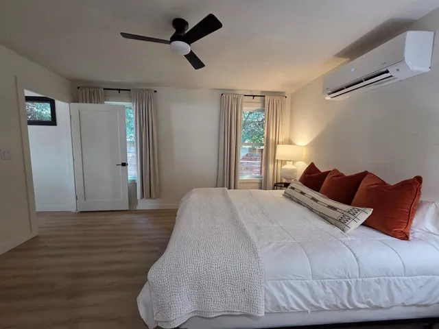 a bedroom with a bed and window