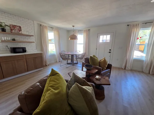 a living room with furniture window and wooden floor