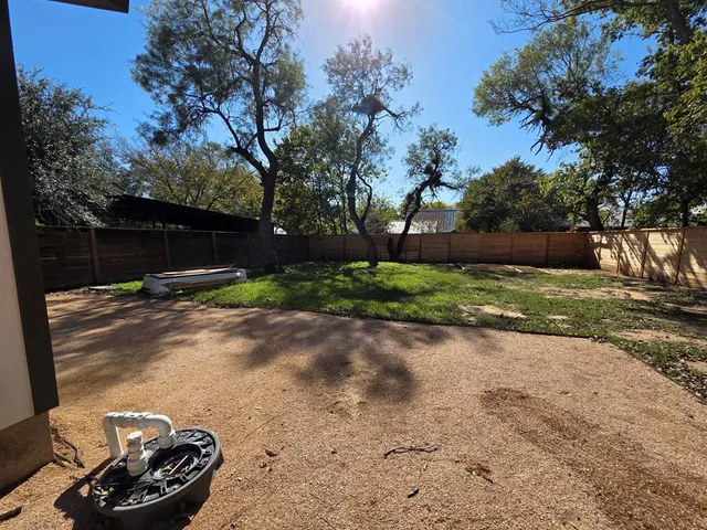 a view of a street with a small yard