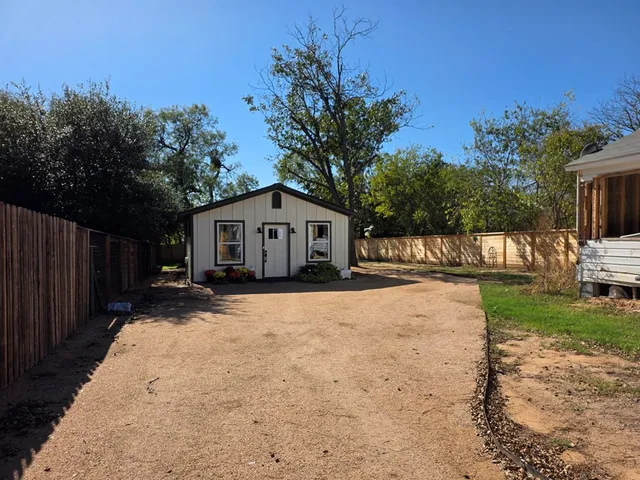 a view of house with yard and entertaining space