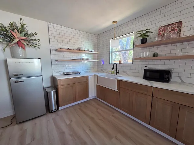a kitchen with a sink cabinets and appliances
