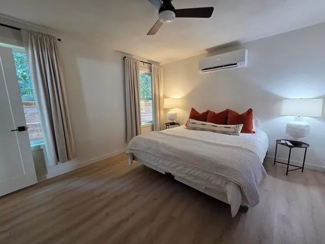 a bedroom with a bed and a mirror