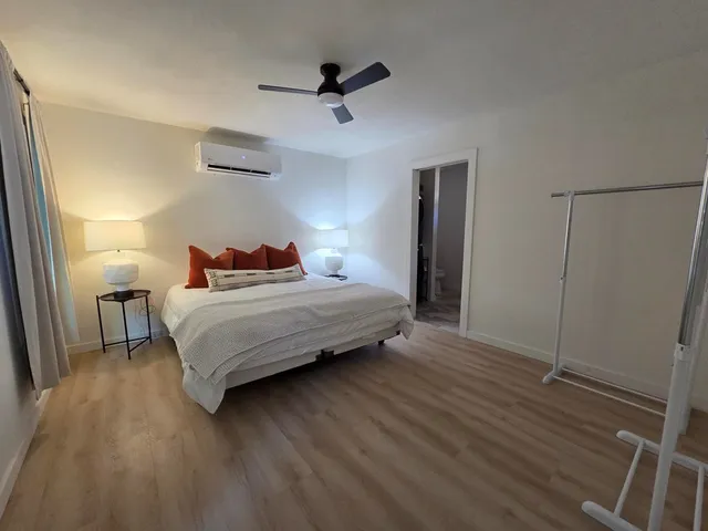 a bedroom with a bed and a ceiling fan