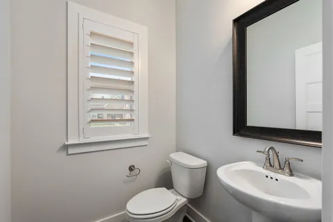 a white toilet sitting next to a bathroom sink