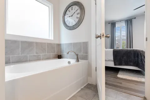 a bathroom with a bathtub and a window
