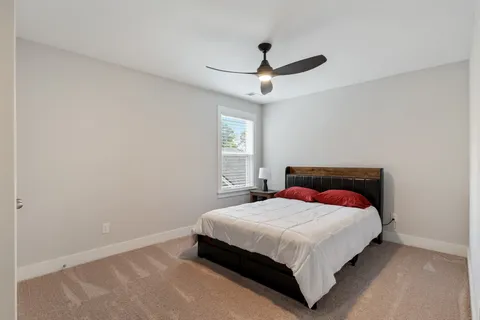 a bedroom with a bed and window