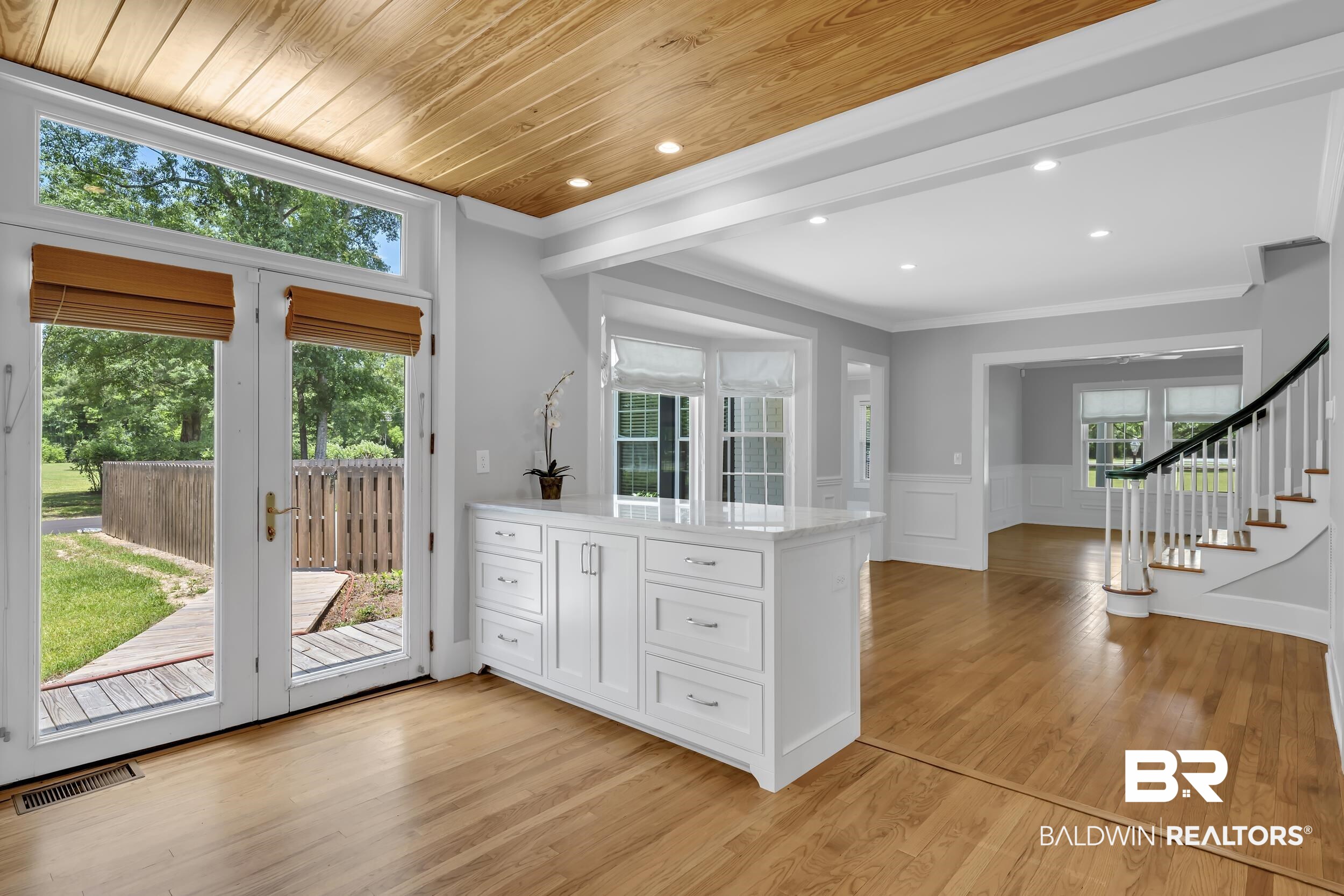 43199 Pine Grove Road Bay Minette, AL 36507 - Photo 35 of 71 Hardwood flooring extends throughout this open living area featuring a custom built-in cabinet with a quartz countertop, recessed lighting, and a wood-paneled ceiling