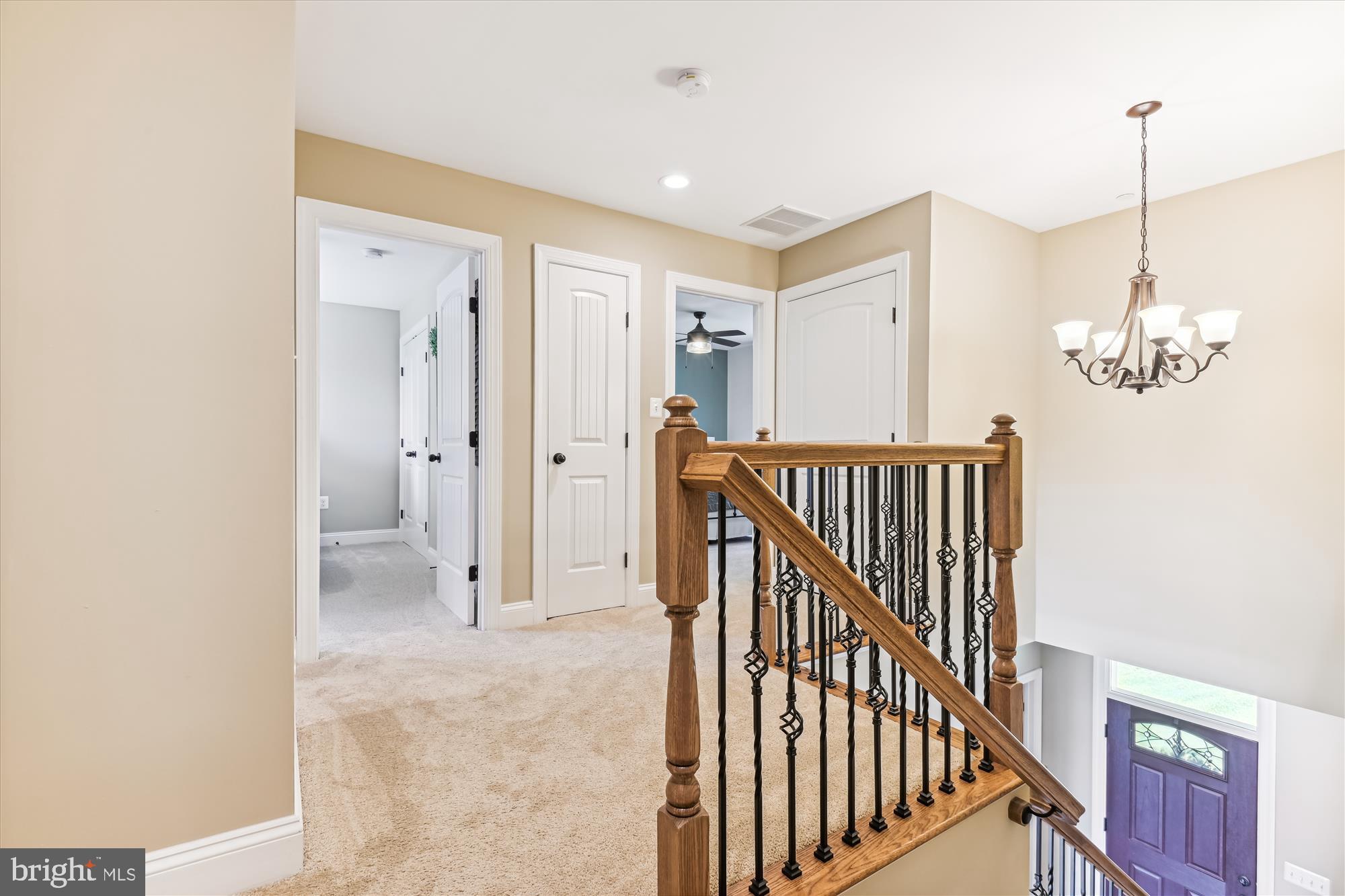 12700 Handboard Road Union Bridge, MD 21791 - Photo 37 of 74 a view of a hallway to a livingroom with wooden floor and stairs