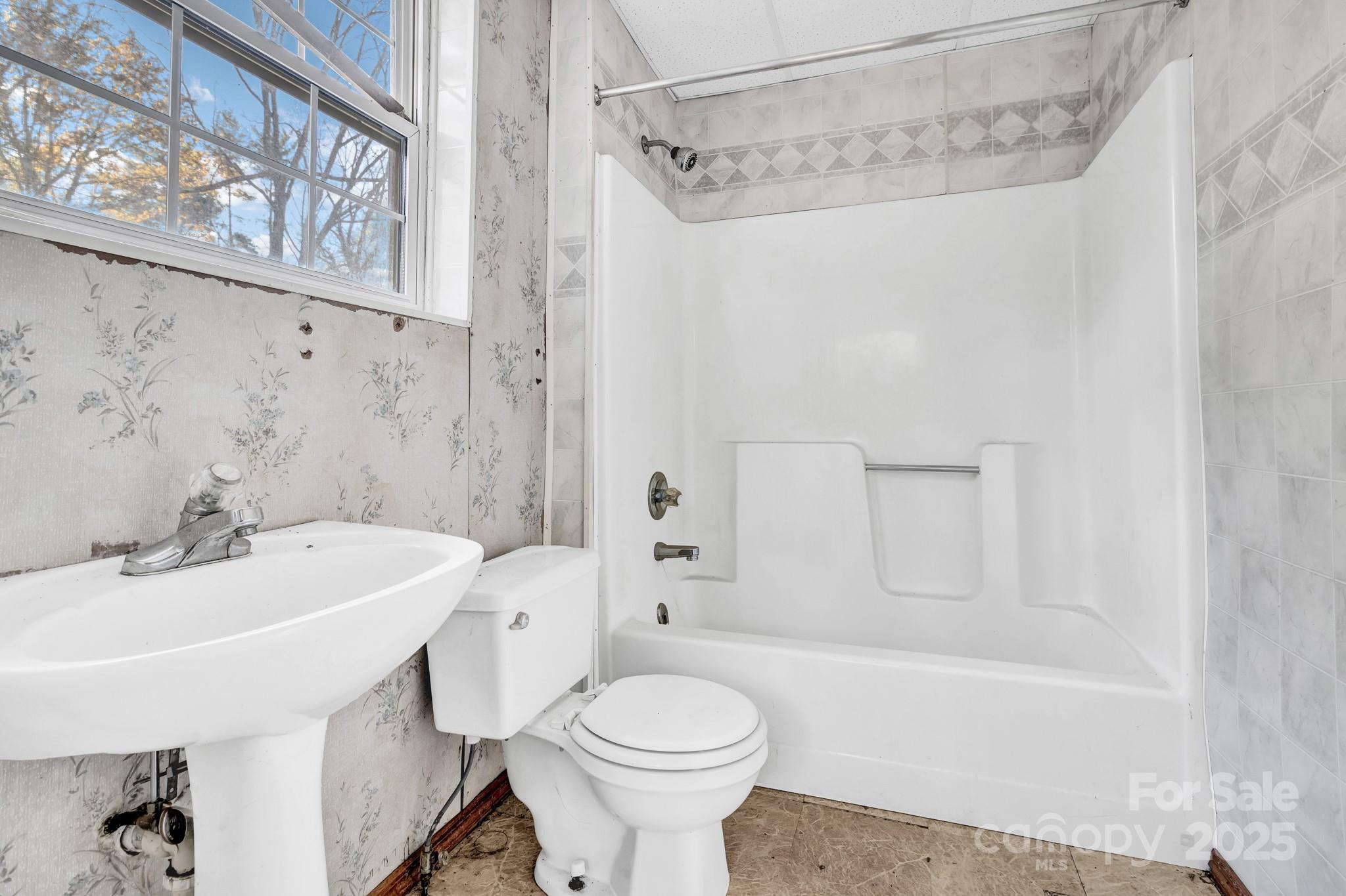 143 Sharon Road Fairview, NC 28730 - Photo 14 of 36 a bathroom with a sink a toilet and a bathtub