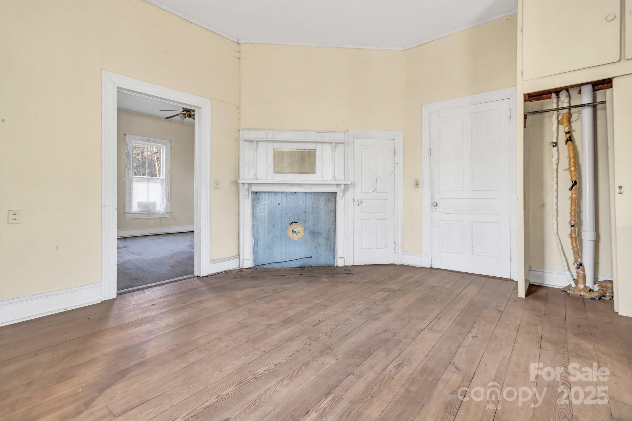 143 Sharon Road Fairview, NC 28730 - Photo 24 of 36 a view of an empty room with wooden floor and a window