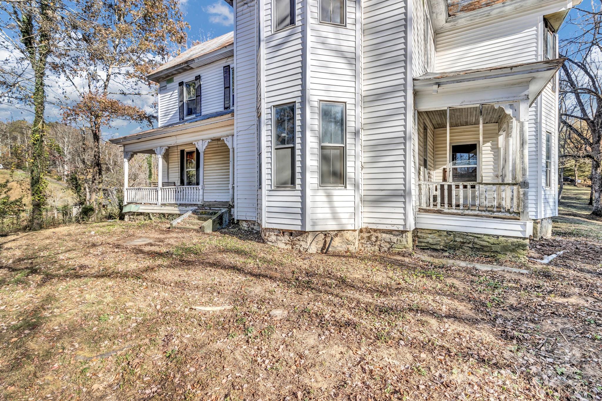 143 Sharon Road Fairview, NC 28730 - Photo 7 of 36 a front view of a house with a yard