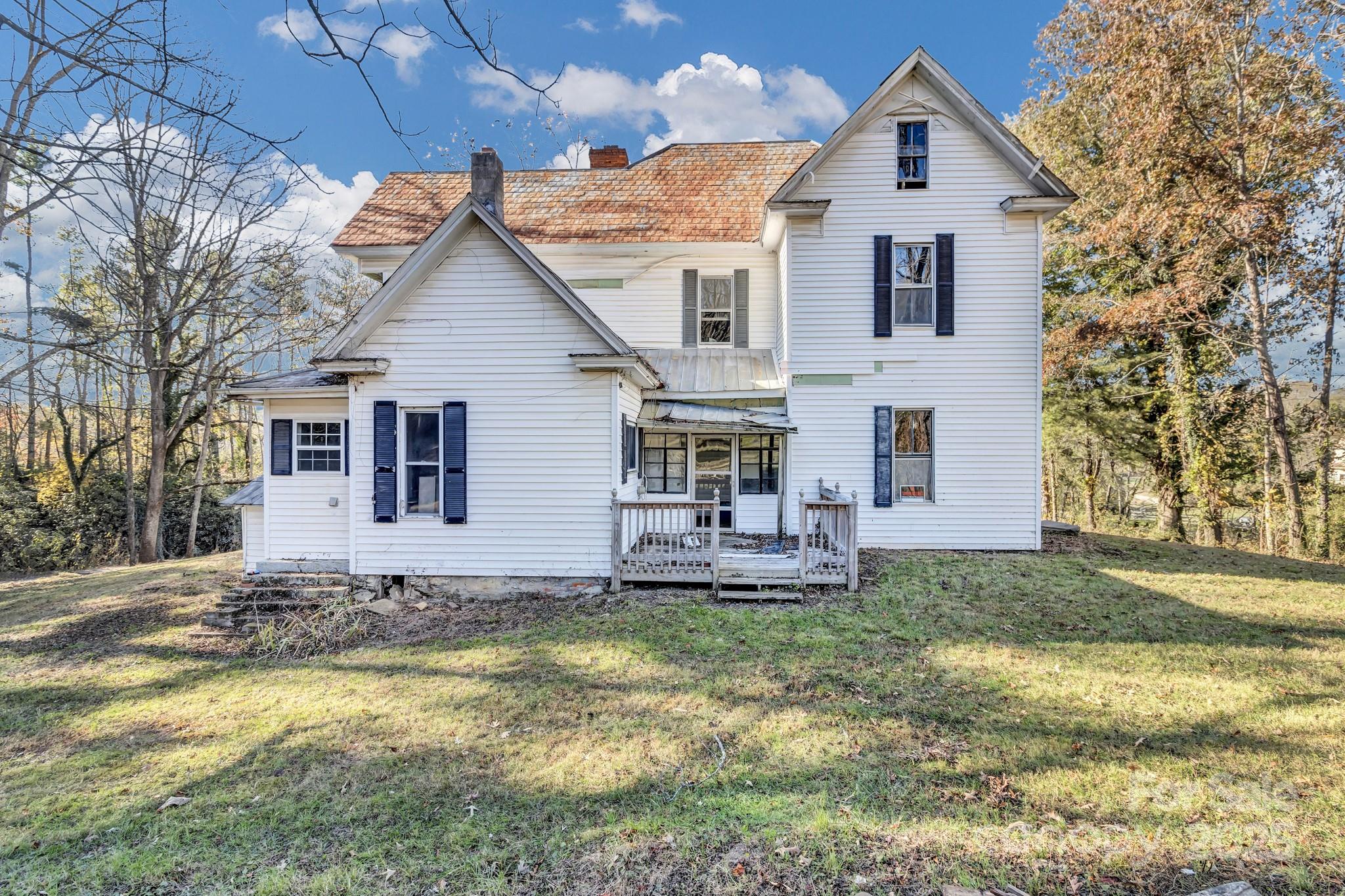 143 Sharon Road Fairview, NC 28730 - Photo 9 of 36 a front view of a house with a yard