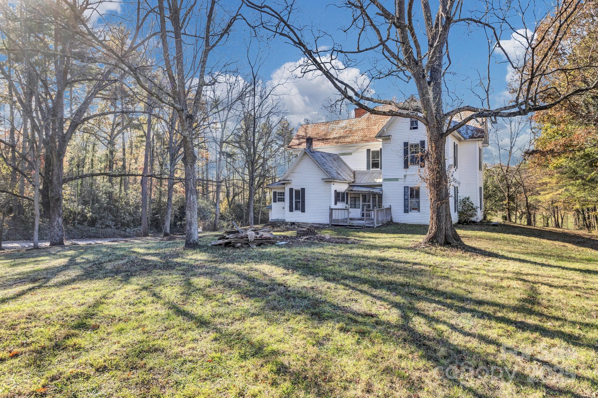 143 Sharon Road Fairview, NC 28730 - Photo 10 of 36 a view of a house with a yard covered with snow