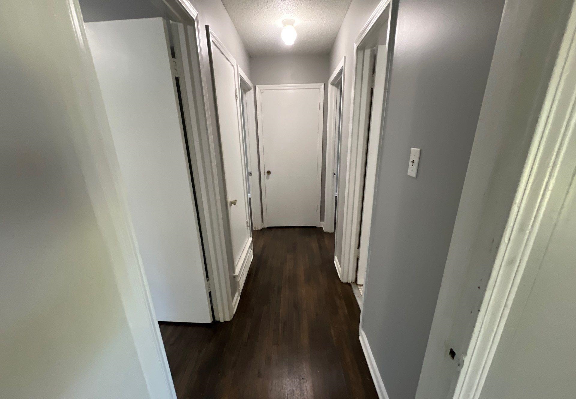4936 Warrington Road Memphis, TN 38118 - Photo 12 of 13 a view of a hallway with wooden floor and staircase