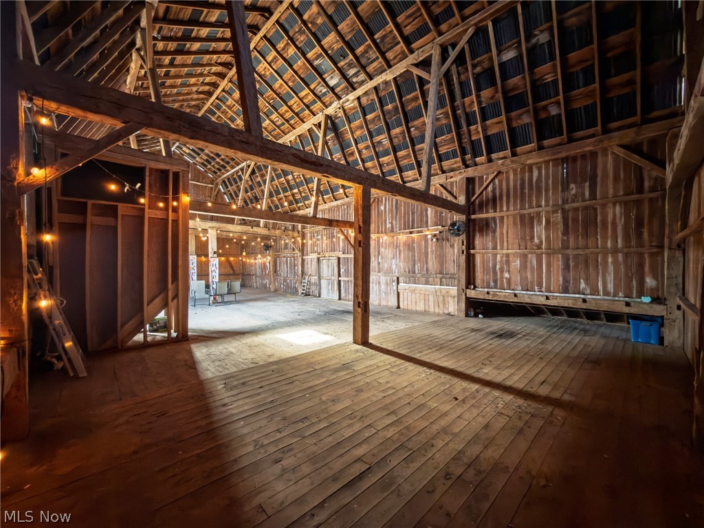 14178 West Road Wakeman, OH 44889 - Photo 13 of 35 Miscellaneous room with hardwood / wood-style flooring, vaulted ceiling, and wooden walls