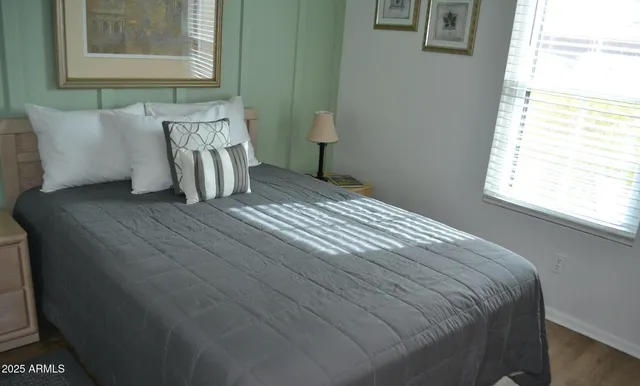 a bed sitting in a bedroom next to a window