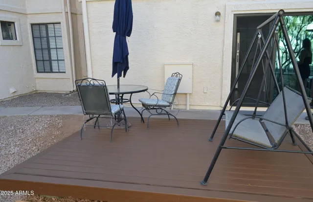 a dining room with furniture and a floor to ceiling window