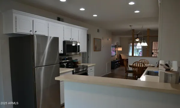 a kitchen with stainless steel appliances a refrigerator and microwave