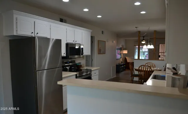 a kitchen with stainless steel appliances a refrigerator and microwave
