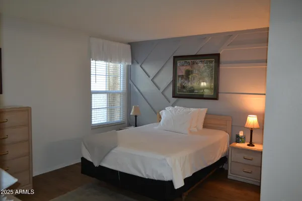 a bedroom with a bed and window