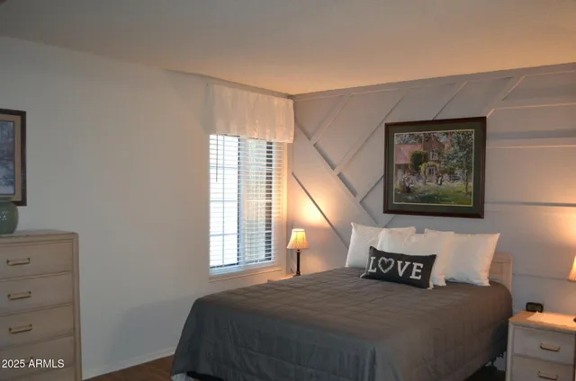 a bedroom with a bed and a window