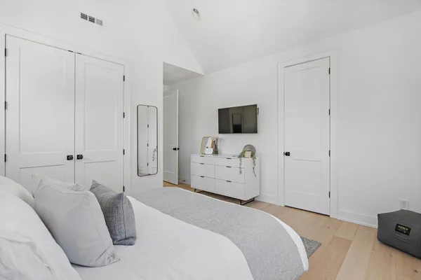 a kitchen with stainless steel appliances granite countertop a sink a stove a refrigerator and white cabinets