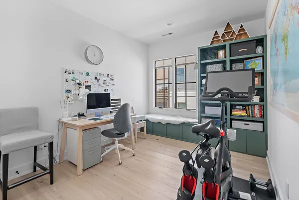 an empty room with windows and closet