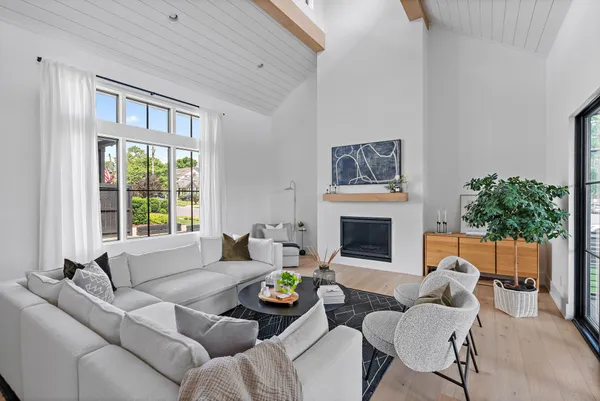 a living room with furniture potted plant and a window