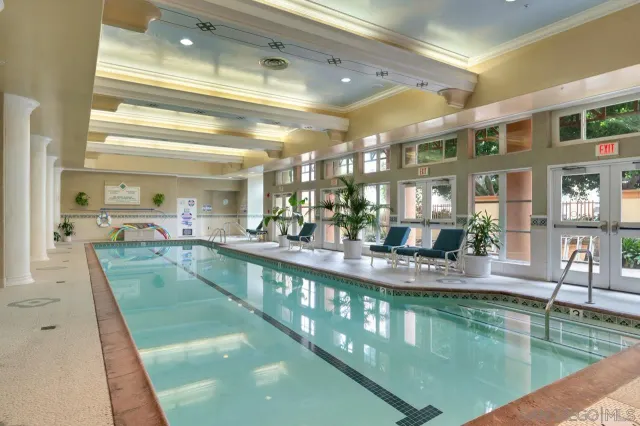 a view of a patio with table and chairs under an umbrella