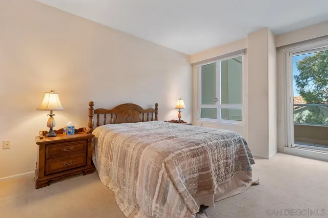 a bedroom with a bed and a night stand