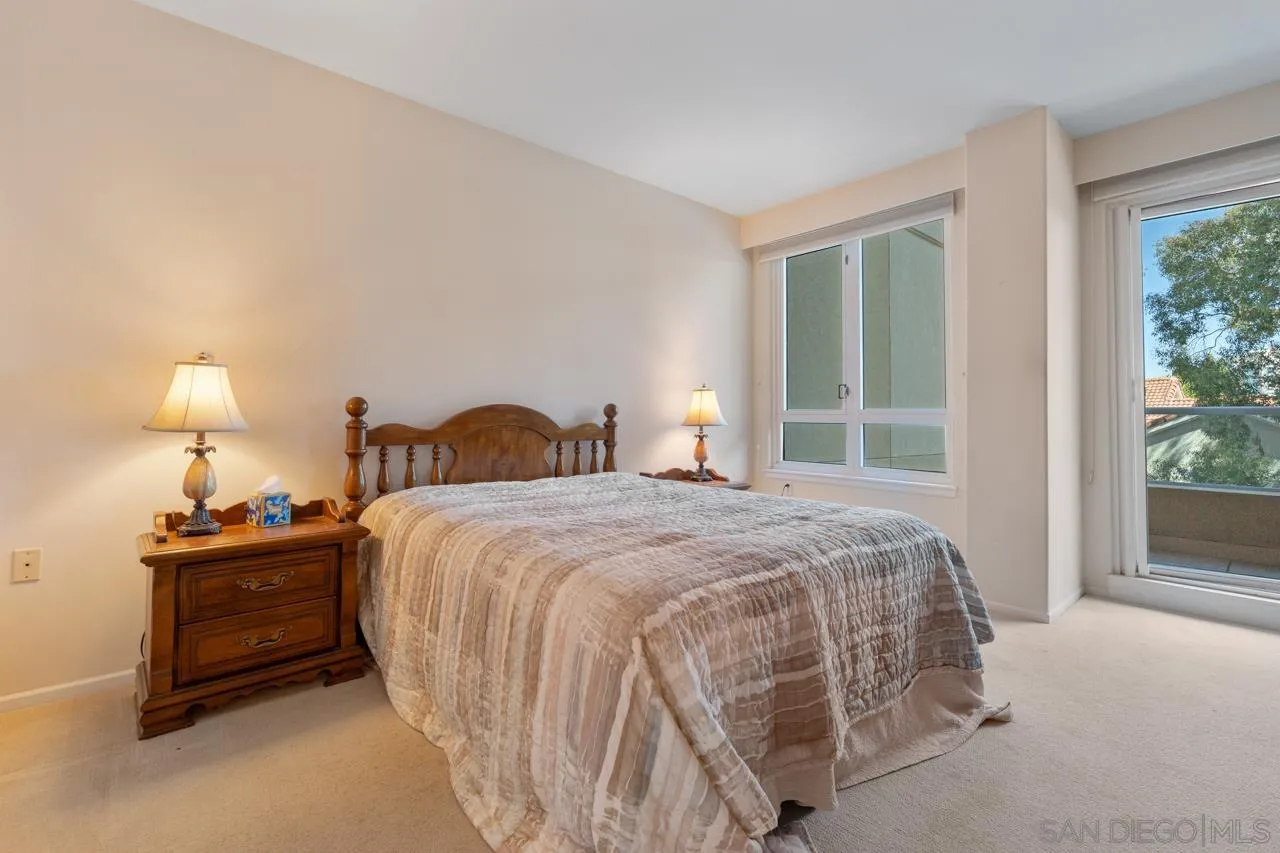 3890 Nobel Drive, Unit 302 San Diego, CA 92122 - Photo 5 of 16 a bedroom with a bed and a night stand