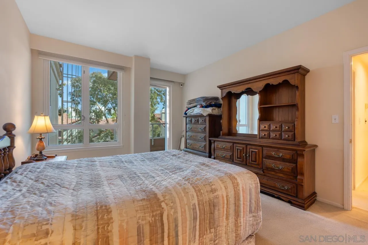 3890 Nobel Drive, Unit 302 San Diego, CA 92122 - Photo 6 of 16 a bedroom with a bed and a dresser next to a window