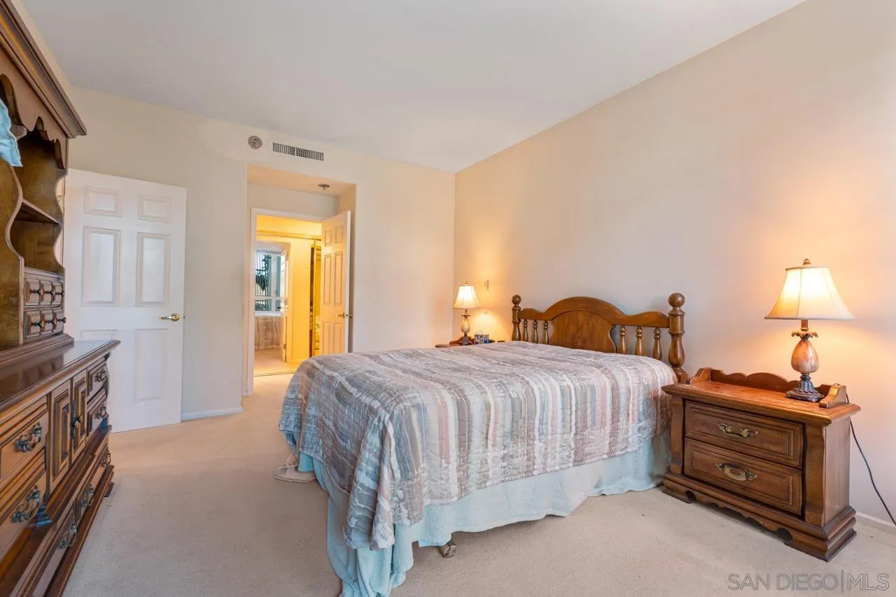 3890 Nobel Drive, Unit 302 San Diego, CA 92122 - Photo 7 of 16 a bedroom with a bed and a flat tv screen on dresser