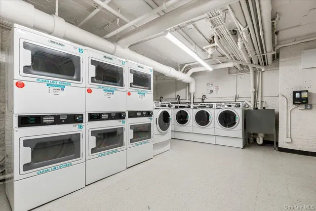 a utility room with stainless steel appliances and white cabinet
